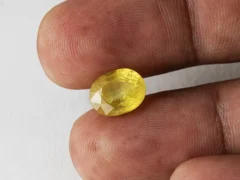 Holding a certified 5.40 ratti pukhraj stone from Ratna Gems