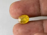 Bangkok yellow sapphire (Pukhraj) 5 Carat (5.49 Ratti), Oval, 10.5mm x 8.2mm x 6.3mm in Hand