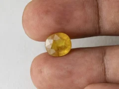 Holding a certified 6.52 ratti pukhraj stone from Ratna Gems
