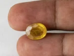Holding a certified 7.54 ratti pukhraj stone from Ratna Gems