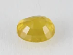 Back view of a 7.68 ratti natural yellow sapphire