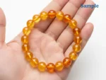 Natural citrine bracelet held in palm for size reference