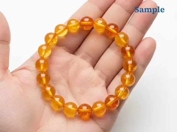 Natural citrine bracelet held in palm for size reference