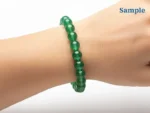 wearing a green aventurine bracelet on wrist
