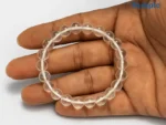 natural rock crystal bracelet held in palm