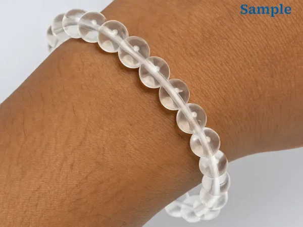 wearing a natural rock crystal bracelet on wrist