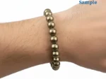 Wearing a golden 163.10 carat natural pyrite bracelet on wrist