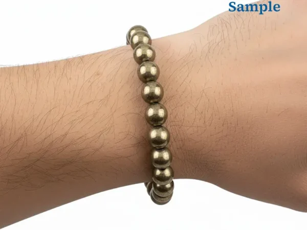 Wearing a golden 163.10 carat natural pyrite bracelet on wrist