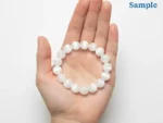 selenite bracelet held in palm for size reference