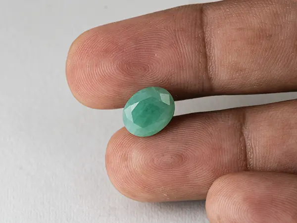 Brazilian Emerald 4.1 Carat (4.51 Ratti) Panna Stone — Sapota 3 Brazilian Emerald 4.1 Carat (4.51 Ratti) Panna Stone in hand — Sapota, true scale and color