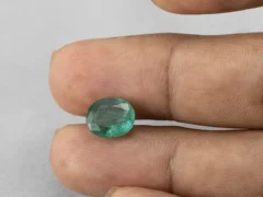 3.35 carat emerald in hand 10.8×8.9×5.4 mm