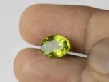 Peridot Stone 5.2 Carat (5.71 Ratti) in hand for real-life scale and color