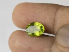 Peridot Stone 5.2 Carat (5.71 Ratti) in hand for real-life scale and color