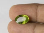 Peridot Stone 5.94 Carat (6.53 Ratti) in hand for real-life scale and color