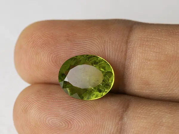 Peridot Stone 5.94 Carat (6.53 Ratti) 3 Peridot Stone 5.94 Carat (6.53 Ratti) in hand for real-life scale and color