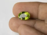 Peridot Stone 6.55 Carat (7.20 Ratti) in hand for true scale and color