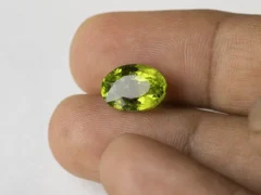 Peridot Stone 6.55 Carat (7.20 Ratti) in hand for true scale and color