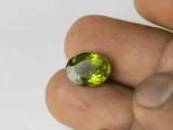 Peridot Stone 6.57 Carat (7.22 Ratti) in hand for real-life scale and color