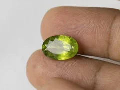 Peridot Stone 6.63 Carat (7.29 Ratti) in hand for true scale and color