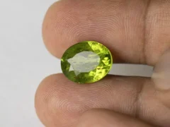 Peridot Stone 7.02 Carat (7.71 Ratti) in hand for real-life scale and color