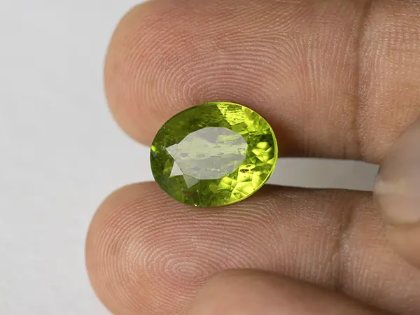 Peridot Stone 7.02 Carat (7.71 Ratti) 3 Peridot Stone 7.02 Carat (7.71 Ratti) in hand for real-life scale and color