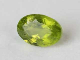 Peridot Stone 7.06 Carat (7.76 Ratti) overhead in natural green Oval Mix Cut