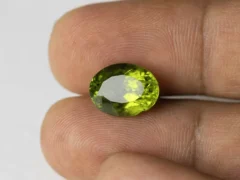 Peridot Stone 7.21 Carat (7.92 Ratti) in hand for real-life scale and color