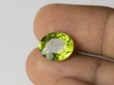 Peridot Stone 7.48 Carat (8.22 Ratti) in hand for real-life scale and color