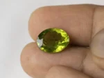 Peridot Stone 7.6 Carat (8.35 Ratti) in hand for true scale and color