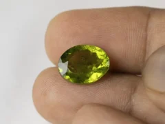 Peridot Stone 7.6 Carat (8.35 Ratti) in hand for true scale and color