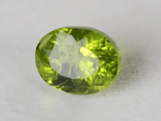 Peridot Stone 7.78 Carat (8.55 Ratti) top view in natural green Oval Mix Cut
