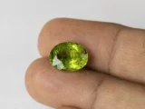 Peridot Stone 8.24 Carat (9.05 Ratti) in hand for real-life scale and color