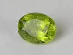 Peridot Stone 9.27 Carat (10.19 Ratti) overhead in natural green Oval Mix Cut