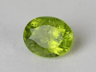 Peridot Stone 9.27 Carat (10.19 Ratti) overhead in natural green Oval Mix Cut