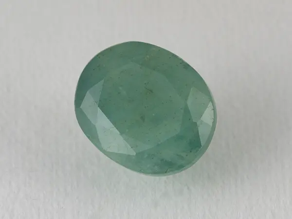 Zambian Emerald 7.15 Carat (7.86 Ratti) Panna Stone 1 Zambian Emerald 7.15 Carat (7.86 Ratti) Panna Stone top view, vivid green oval