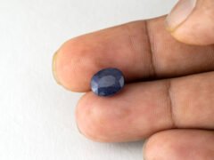 Bangkok Blue Sapphire Neelam 4.95 Carat in hand showing real size 10.2mm length