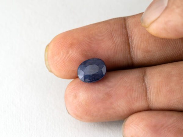 Bangkok Blue Sapphire Neelam 4.95 Carat in hand showing real size 10.2mm length