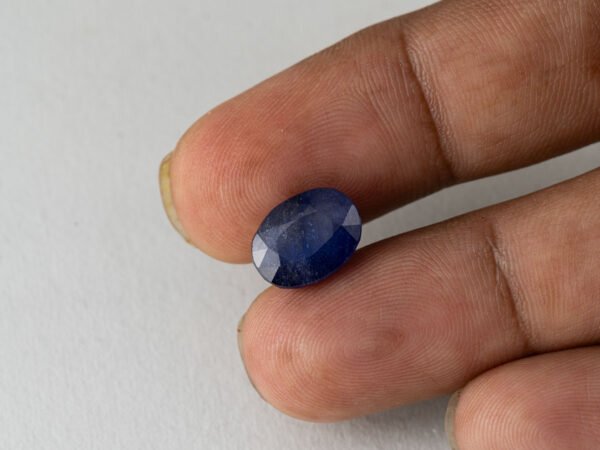 Bangkok Blue Sapphire Neelam 6.5 Carat in hand showing real size 12.5mm length