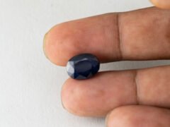 Bangkok Blue Sapphire Neelam 7.22 Carat in hand showing real size 12.9mm length