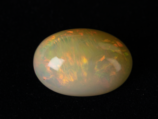 Ethiopian Fire Opal 10.02 Carat natural certified oval cut loose gemstone with rainbow play-of-color