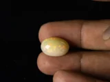 Ethiopian Fire Opal 10.02 Carat in hand showing impressive real size 18.7x12.9mm spread