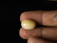 Ethiopian Fire Opal 10.02 Carat in hand showing impressive real size 18.7x12.9mm spread