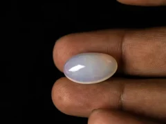 Ethiopian Fire Opal 10.50 carat in hand showing 21.9mm length elongated shape