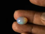 Ethiopian Fire Opal 4.10 Carat in hand showing generous 15.2x11.8mm spread actual size