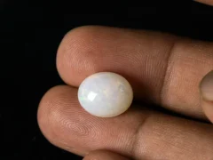 Ethiopian Fire Opal 6.60 Carat in hand showing actual size 14.2x11.7mm spread