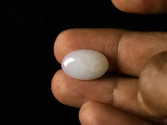 Ethiopian Fire Opal 7.94 Carat in hand showing real size 20.2x13.3mm spread