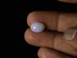 Ethiopian Fire Opal 3.40 carat in hand showing 12.9mm actual size