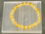 Natural Citrine bracelet with transparent yellow beads on selenite charging plate