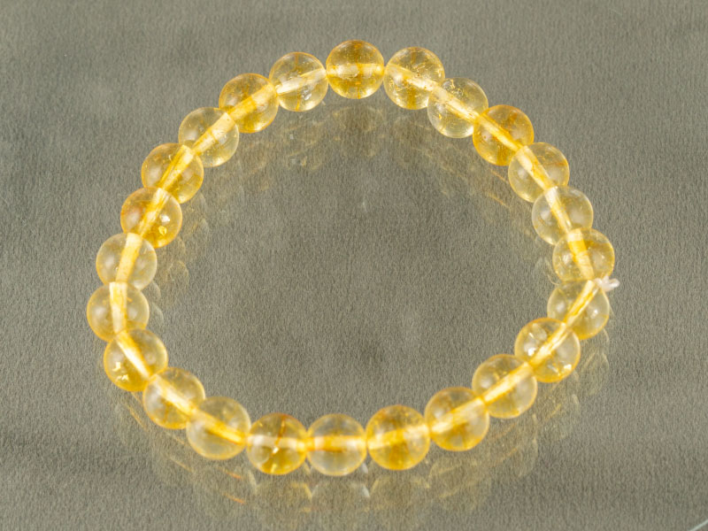 Natural Citrine (Sunela) Bracelet – Certified 8mm 2 Top view of round 8mm Citrine gemstone bracelet isolated on grey background