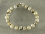 Top view of 8mm round Labradorite beads bracelet isolated on grey background